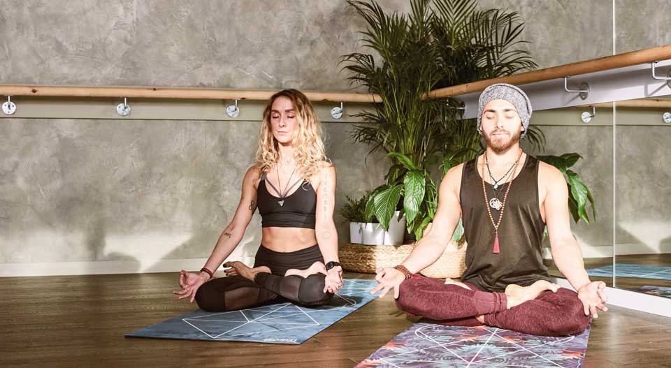 a woman and a men doing yoga